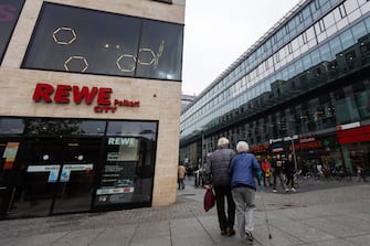 Elderly shoppers pass a Rewe supermarket, operated by the Rewe Group, in Dresden, Germany, on Thursday, Oct. 19, 2023. As the European Union's biggest economy wrestles with a persistent slump and a surge in immigration, the specter of German nationalism has returned, leaving citizens more conflicted over their country's direction than at any point since World War II. Photographer: Krisztian Bocsi/Bloomberg via Getty Images