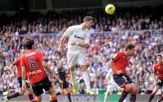 MADRID, SPAIN - NOVEMBER 06:  Cristiano Ronaldo of Real Madrid scores his third goal during the La Liga match between Real Madrid and Osasuna at Estadio Santiago Bernabeu on November 6, 2011 in Madrid, Spain.  (Photo by Denis Doyle/Getty Images)