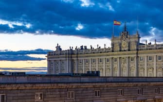 A picture of the Royal Palace of Madrid at sunset.