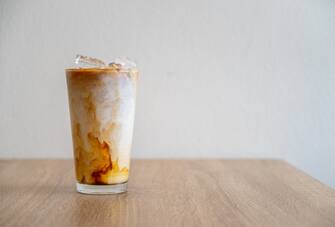 An iced latte is a drink with espresso, milk and optional sweetener.