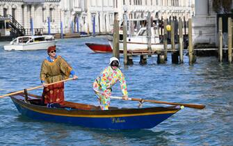 A man dressed as Arlequin rows during a parade on the Grand Canal at Venice Carnival, on February 16, 2025. This year, the theme of one of the most famous carnival in the world is Casanova, as the 'Serenissima' celebrates the 300th anniversary of the famous man's birth. (Photo by ANDREA PATTARO / AFP)
