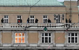 TOPSHOT - Armed police are seen on the balcony of the Charles University in central Prague, on December 21, 2023. Czech police said a shooting in a university building in central Prague has left "dead and wounded people", without providing further details.
"Based on the initial information we have, we can confirm dead and wounded people on the scene," police said on X, formerly Twitter. Czech media said the shooting had occurred at the Faculty of Arts whose teachers and students were instructed to lock themselves up as the police action was under way. (Photo by Michal CIZEK / AFP) (Photo by MICHAL CIZEK/AFP via Getty Images)