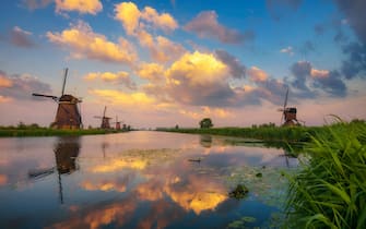 Sunset above old dutch windmills in Kinderdijk, Netherlands
