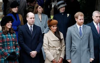 Britain's Catherine, Duchess of Cambridge, (L) and Britain's Prince William, Duke of Cambridge, (2L), US actress and fiancee of Britain's Prince Harry Meghan Markle (2R) and Britain's Prince Harry (R) stand together as they wait to see off Britain's Queen Elizabeth II after attending the Royal Family's traditional Christmas Day church service at St Mary Magdalene Church in Sandringham, Norfolk, eastern England, on December 25, 2017. (Photo by Adrian DENNIS / AFP) (Photo by ADRIAN DENNIS/AFP via Getty Images)