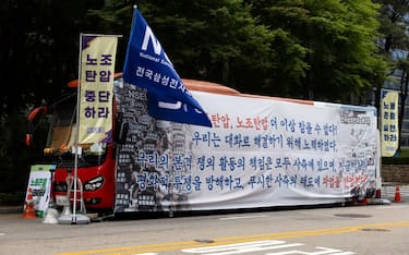 A bus from the National Samsung Electronics Union (NSEU) outside Samsung Electronics Co.'s Seocho office building in Seoul, South Korea, on Friday, June 7, 2024. The largest union at Samsung Electronics went on a strike for the first time in the company's 55-year history, with the standoff over pay so entrenched that the two sides have stopped all discussions. Photographer: SeongJoon Cho/Bloomberg via Getty Images