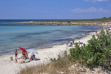 Italian tourists swimming and sunbathing on sandy beach in summer along the Ionian Sea in the Province of Lecce, Apulia region in Southern Italy. (Photo by: Marica van der Meer/Arterra/Universal Images Group via Getty Images)