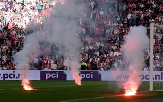 AMSTERDAM, NETHERLANDS - SEPTEMBER 24: Supporters of Ajax thrown for the third time fireworks on the pitch during the Dutch Eredivisie  match between Ajax v Feyenoord at the Johan Cruijff Arena on September 24, 2023 in Amsterdam Netherlands (Photo by Pim Waslander/Soccrates Images/Getty Images)