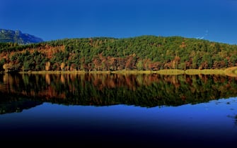The wonderful colors of autumn reflected in the mirror of water