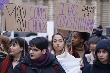Placards reading "My body my choice" (L) and "Abortion in the Constitution" are seen during a  rally to call for the constitutionalisation of the right to abortion outside the Senate in Paris, on February 01, 2023. (Photo by Ludovic MARIN / AFP) (Photo by LUDOVIC MARIN/AFP via Getty Images)
