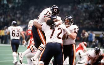 NEW ORLEANS, LA - JANUARY 26:  William Perry #72, Stean Humphries #75 and Tom Thayer #57 of the Chicago Bears celebrates after Perry scored a touchdown against the New England Patriots during Super Bowl XX January 26, 1986 at the Louisiana Superdome in New Orleans, Louisiana. The Bears won the Super Bowl 46-10. (Photo by Focus on Sport/Getty Images)