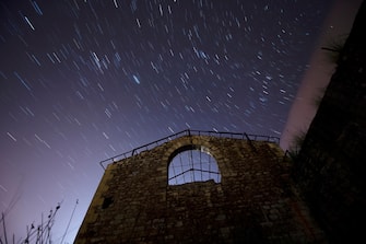 epa09664253 An overlay image of 20 photographs shows the Quadrantids, the first meteor shower of 2022, over the village of Hinojedo, in Cantabria, northern Spain, early 03 January 2022. EPA/PEDRO PUENTE HOYOS