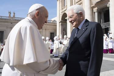 A handout picture provided by the Vatican Media shows Pope Francis (L)  shakes hands with the President of the Italian Republic, Sergio Mattarella (R), at the end of the Holy Mass and Canonization of ten Blessed in Saint Peter's Square, Vatican City, 15 May 2022.  ANSA/VATICAN MEDIA HANDOUT HANDOUT EDITORIAL USE ONLY/NO SALES