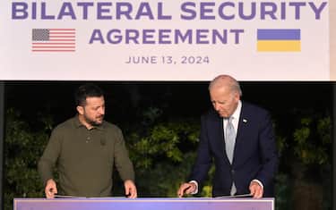US President Joe Biden (R) and Ukrainian President Volodymyr Zelensky (L)  sign a bilateral security agreement after a bilateral meeting on the sidelines of the G7 summit in Savelletri (Brindisi), southern Italy, 13 June 2024. ANSA/ETTORE FERRARI

