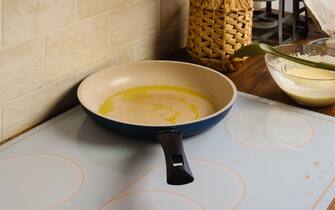 Frying pan with olive oil on an electric kitchen stove