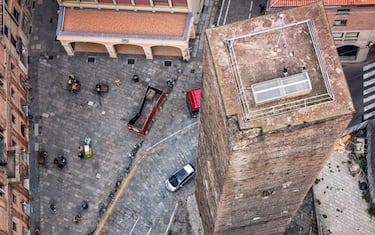 Bologna, Italy - October 12, 2013: View of the top of the Garisenda Tower from the Asinelli Tower