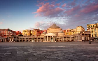 Naples, Italy. Cityscape image of Naples, Italy with the view of large public town square Piazza del Plebiscito at sunrise.