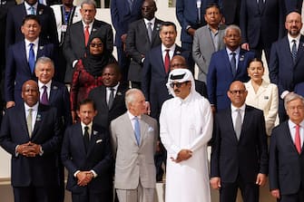 DUBAI, UNITED ARAB EMIRATES - DECEMBER 01: King Charles III (C) speaks with Qatari Emir Sheikh Tamim bin Hamad Al Thani as they join fellow heads of state for a group photo during day one of the high-level segment of the UNFCCC COP28 Climate Conference at Expo City Dubai on December 01, 2023 in Dubai, United Arab Emirates. The COP28, which is running from November 30 through December 12, brings together stakeholders, including international heads of state and other leaders, scientists, environmentalists, indigenous peoples representatives, activists and others to discuss and agree on the implementation of global measures towards mitigating the effects of climate change. (Photo by Sean Gallup/Getty Images)