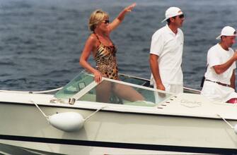 SAINT-TROPEZ, FRANCE - JULY 17: Diana, Princess of Wales, wearing an animal print, halterneck swimsuit and sunglasses, has fun on a boat on July 17, 1997 in Saint-Tropez, France. (Photo by Anwar Hussein/WireImage)