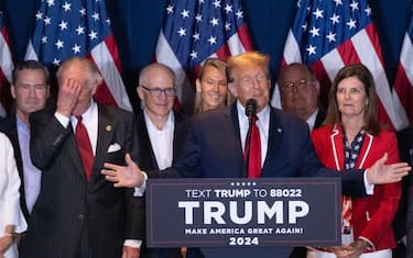 Former US President Donald Trump, center right, speaks during an election night watch party at the South Carolina State Fairgrounds in Columbia, South Carolina, US, on Saturday, Feb. 24, 2024. Trump won the Republican presidential primary in South Carolina, according to AP, delivering a blow to rival Nikki Haley in her home state as the former president continues his sweep of the 2024 nominating contests. Photographer: Victor J. Blue/Bloomberg via Getty Images