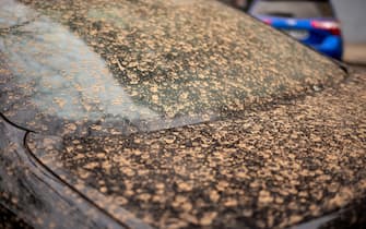 Dust and dirt on a car due to a sand storm arriving from the sahara in Madrid
