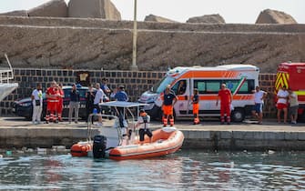 Ambulances with health workers wait on the pier to rescue the seven missing people who were on board the sailing boat that sank at dawn this morning in Palermo, Sicily, Italy,  19 August  2024. A 56-meter-long luxury sailboat, the Bayesian, with 22 people on board, sank at dawn on Monday off Porticello, near Palermo, after a tornado hit the area. At least six missing, one dead in Palermo shipwreck 
ANSA/IGOR PETYX