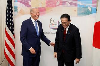 US President Joe Biden (L) is greeted by Japan's Prime Minister Fumio Kishida before their bilateral meeting in Hiroshima on May 18, 2023, ahead of the G7 Leaders' Summit. (Photo by Kiyoshi Ota / POOL / AFP) (Photo by KIYOSHI OTA/POOL/AFP via Getty Images)