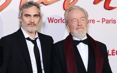 PARIS, FRANCE - NOVEMBER 14: Giannina Facio, Joaquin Phoenix and Director Ridley Scott attend the "Napoleon" World Premiere at Salle Pleyel  on November 14, 2023 in Paris, France. (Photo by Marc Piasecki/Getty Images)