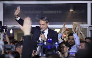 epa10644758 Greek Prime Minister and leader of New Democracy political party, Kyriakos Mitsotakis, greets supporters after the announcement of the first results of the Greek general elections, at the headquarter's party, in Athens, 21 May 2023. The joint exit poll of nationwide television stations in Greece showed a comfortable lead of ruling New Democracy party during national elections on Sunday, after polls shut down at 7:00 p.m.  EPA/GEORGE VITSARAS