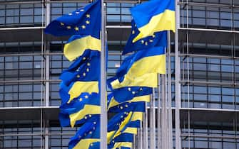 A picture taken on February 24, 2023 shows European Union's and Ukrainian flags fluttering outside the European Parliament in Strasbourg, eastern France, to mark the first anniversary of the Russian invasion of Ukraine. (Photo by PATRICK HERTZOG / AFP) (Photo by PATRICK HERTZOG/AFP via Getty Images)