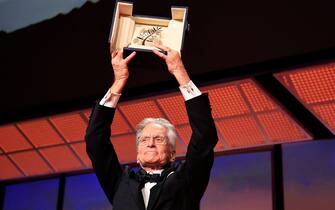 US actor Michael Douglas holds up the Honorary Palme d'or of he 76th Cannes Film Festival he received during the opening ceremony in Cannes, southern France, on May 16, 2023. (Photo by Valery HACHE / AFP) (Photo by VALERY HACHE/AFP via Getty Images)