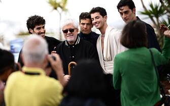 Spanish film director Pedro Almodovar (C) poses with Portuguese actor Jose Condessa (L), Spanish actor Jason Fernandez (3rdR), Spanish actor Manu Rios (2ndR) and actor George Steane during a photocall for the film "Extrana Forma de Vida" (Strange Way of Life) at the 76th edition of the Cannes Film Festival in Cannes, southern France, on May 17, 2023. (Photo by LOIC VENANCE / AFP) (Photo by LOIC VENANCE/AFP via Getty Images)