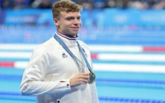 epa11520627 Gold medalist Leon Marchand of France poses for photos after the podium for the Men 200m Individual Medley final of the Swimming competitions in the Paris 2024 Olympic Games, at the Paris La Defense Arena in Paris, France, 02 August 2024.  EPA/RITCHIE B. TONGO