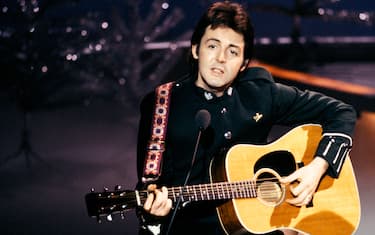 UNITED KINGDOM - DECEMBER 10:  BBC TV CENTRE  Photo of WINGS and Paul McCARTNEY, in Wings, performing on TV show, playing acoustic guitar, on Mike Yarwood Christmas Special  (Photo by David Redfern/Redferns)