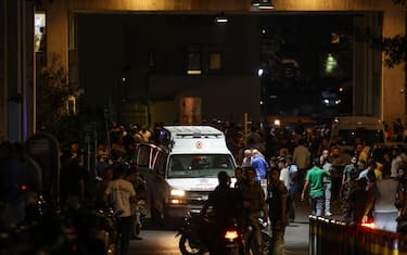 Ambulances are surrounded by people at the entrance of the American University of Beirut Medical Center, on September 17, 2024, after explosions hit locations in several Hezbollah strongholds around Lebanon amid ongoing cross-border tensions between Israel and Hezbollah fighters. Hundreds of people were wounded when Hezbollah members' paging devices exploded simultaneously across Lebanon on September 17, in what a source close to the militant movement said was an "Israeli breach" of its communications. (Photo by ANWAR AMRO / AFP)