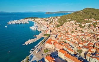 Aerial view of Split, Croatia. Cityscape of coastal touristic city with harbor. Old town with historical red roof tiled buildings near Adriatic Sea