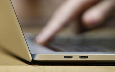 epa06417905 (FILE) - A guest inspects the new MacBook Pro computer with the new USB-C ports in a demo room, following the announcement of new products at the Apple Headquarters in Cupertino, California, USA, 27 October 2016 (reissued 05 January 2018). According to reports, Apple has admitted its iPhone and Mac products are affected by two considerable security flaws in the hardware chips. Several technology companies are rushing to fix two considerable flaws in popular computer chips manufactured by Intel, AMD and ARM. The flaws could help attackers to gain access to sensitive information such as banking information and passwords. It is not known if the boards and chips pictured contain the security vulnerability.  EPA/TONY AVELAR