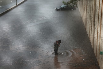 NEW YORK, NEW YORK - SEPTEMBER 29: A person walks away from his vehicle after it got stuck in high water on the Prospect Expressway during heavy rain and flooding on September 29, 2023 in New York City. Much of the Northeast is experiencing severe flooding after heavy rains swept through the area this morning. (Photo by Spencer Platt/Getty Images)