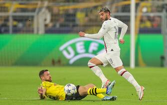 epa10900338 Dortmund's Salih Oezcan (L) and Milan's Theo Hernandez (R) in action during the UEFA Champions League Group F match between Borussia Dortmund and AC Milan in Dortmund, Germany, 04 October 2023.  EPA/FRIEDEMANN VOGEL