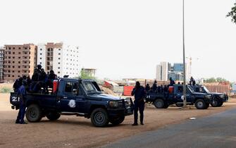 epa08558650 Police officers stand gaurd outside the courthouse, where former Sudanese president Omar al-Bashir and more than 20 others are tried for their role in the 1989 military takeover of the government, Khartoum, Sudan, 21 July 2020. The former Sudanese president and more than 20 other people are on trial for the 1989 military takeover of the country.  EPA/MOHAMMED ABU OBAID