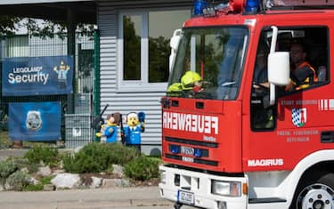 11 August 2022, Bavaria, GÃ¼nzburg: A fire truck drives past the entrance to Legoland. At least 34 people were injured, two of them seriously, in an accident on a roller coaster at Legoland in GÃ¼nzburg, Swabia. Photo: Stefan Puchner/dpa (Photo by Stefan Puchner/picture alliance via Getty Images)