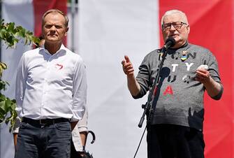 Donald Tusk, leader of the Polish Civic Platform (Platforma Obywatelska (PO) party (L) and Poland's former president Lech Walesa speak during an anti-government demonstration organized by the opposition in Warsaw on June 4, 2023. Coming from all over Poland, the demonstrators took up the call of the leader of the main centrist opposition party (Civic Platform, PO), former head of the European Council Donald Tusk, to protest against "high living costs, swindling and lies, in favor of democracy, free elections and the EU". (Photo by Wojtek Radwanski / AFP) (Photo by WOJTEK RADWANSKI/AFP via Getty Images)