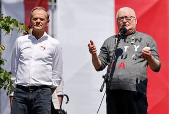 Donald Tusk, leader of the Polish Civic Platform (Platforma Obywatelska (PO) party (L) and Poland's former president Lech Walesa speak during an anti-government demonstration organized by the opposition in Warsaw on June 4, 2023. Coming from all over Poland, the demonstrators took up the call of the leader of the main centrist opposition party (Civic Platform, PO), former head of the European Council Donald Tusk, to protest against "high living costs, swindling and lies, in favor of democracy, free elections and the EU". (Photo by Wojtek Radwanski / AFP) (Photo by WOJTEK RADWANSKI/AFP via Getty Images)