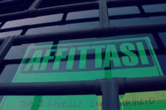 Sign "Affittasi" in Italian translating in "For Rent"concept of crisis .