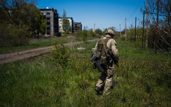 A Ukrainian serviceman of the State Border Guard Service patrols in Chasiv Yar near the frontline city of Bakhmut, Donetsk region on May 3, 2023, amid the Russian invasion of Ukraine. (Photo by Dimitar DILKOFF / AFP)