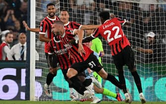 AC Milan's Serbian defender #31 Strahinja Pavlovic (C) celebrates after scoring his team's first goal during the Italian Serie A football math between Lazio and Milan at the Olympic stadium in Rome on August 31, 2024. (Photo by tiziana fabi / AFP)