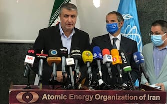 epa09463127 A handout picture made available by the Iran Atomic Organization official website (aeoi) shows, Iranian Atomic Organization chief Mohammad Eslami (L) and Rafael Mariano Grossi (C), Director General of the International Atomic Energy Agency (IAEA) during a joint press conference in Tehran, Iran, 12 September 2021. Grossi is in Tehran to meet with Iranian officials.  EPA/AEOI HANDOUT  HANDOUT EDITORIAL USE ONLY/NO SALES