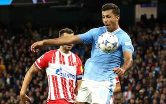 epa10870382 Rodri (R) of Manchester City in action against Aleksandar Dragovic of Red Star during the UEFA Champions League Group G match between Manchester City and Red Star Belgrade in Manchester, Britain, 19 September 2023.  EPA/ADAM VAUGHAN