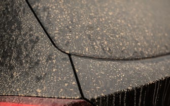 the varnish of a black car in Germany covered by sahara dust transported with the wind