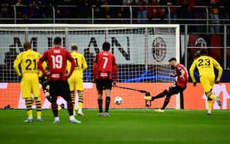 AC Milan's French forward #09 Olivier Giroud misses a penalty shot during the UEFA Champions League Group F football match between AC Milan and Borussia Dortmund at the San Siro stadium in Milan on November 28, 2023. (Photo by Marco BERTORELLO / AFP)