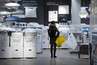 epa09078011 A customer looks on at an IKEA store in Amsterdam, the Netherlands, 16 March 2021. Due to the relaxation of the coronavirus rules, large stores may receive a maximum of fifty customers per time slot instead of two.  EPA/JEROEN JUMELET